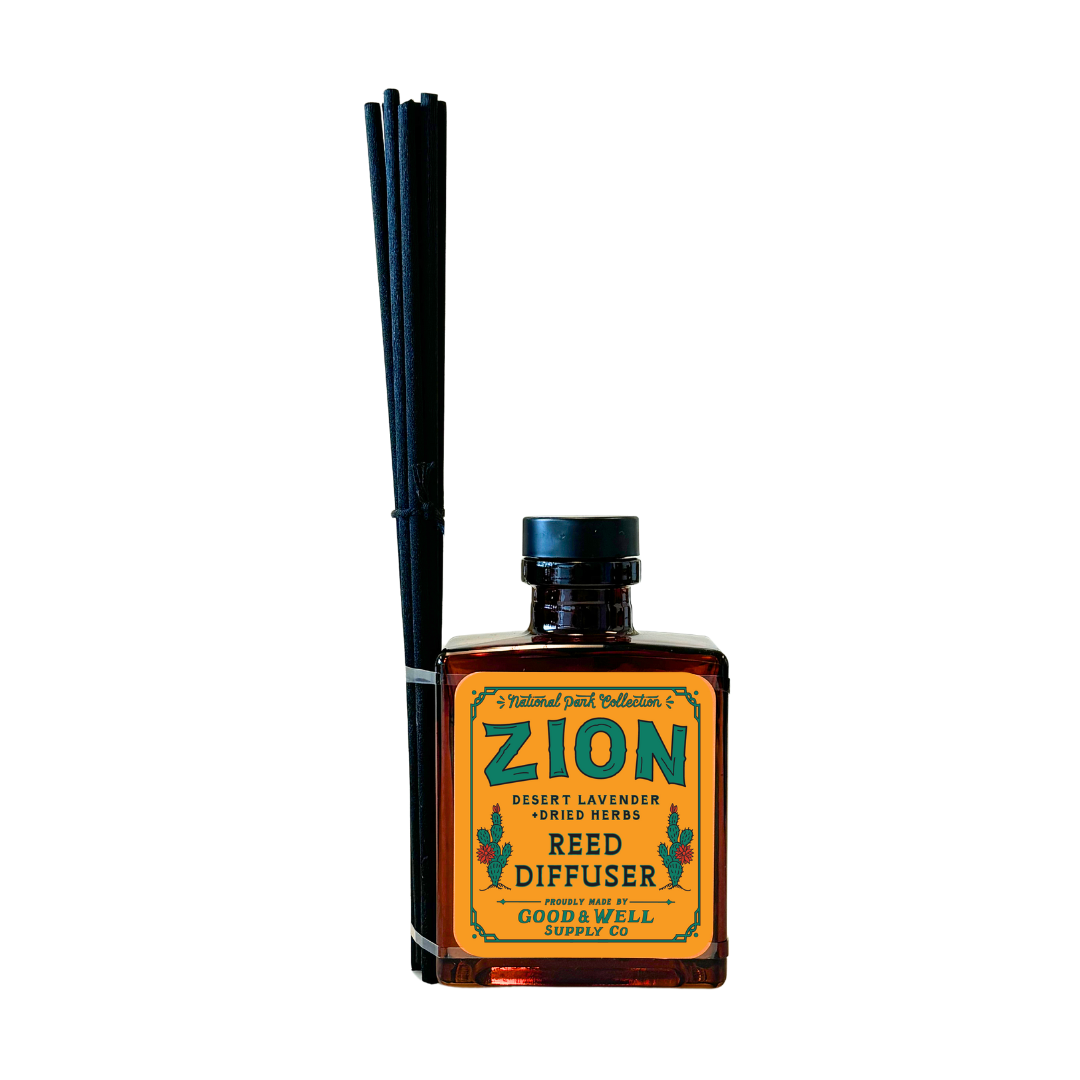Zion reed diffuser with amber glass bottle and black reeds by Good & Well Supply Co., scented with desert lavender and herbs.