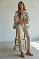 Quilted cotton jacket with desert-themed motifs and soft blue, cream, and terracotta tones