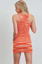 Woman wearing a Colorwave Sleeveless Knit Dress with a colorful wave pattern.