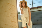 Model wearing cream-colored crochet wide-leg pants with intricate patterns and a high waist.