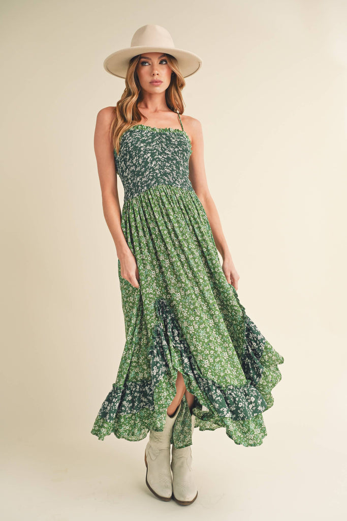 Panoramic view of the enchanting Deeane Ruffle Dress in vibrant green with floral pattern.