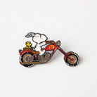 Snoopy and Woodstock enamel pin on a red motorcycle, perfect for Peanuts fans and motorcycle enthusiasts.