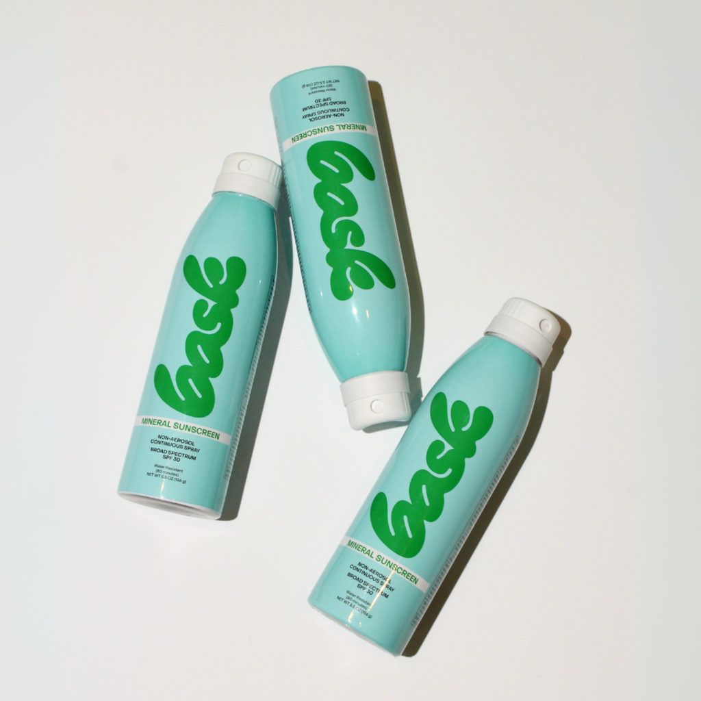 A bottle of Bask SPF 30 Mineral Non-Aerosol Spray with a turquoise label on a white background.