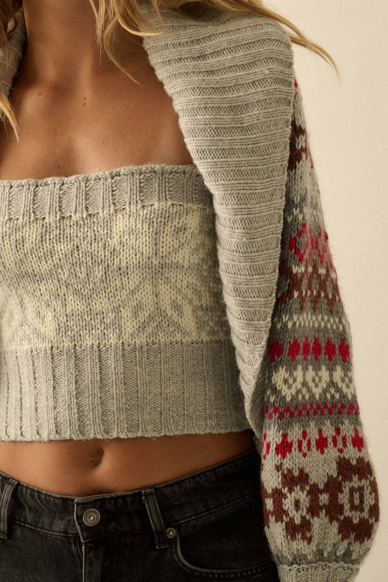 Person wearing a patterned sweater with a neutral background