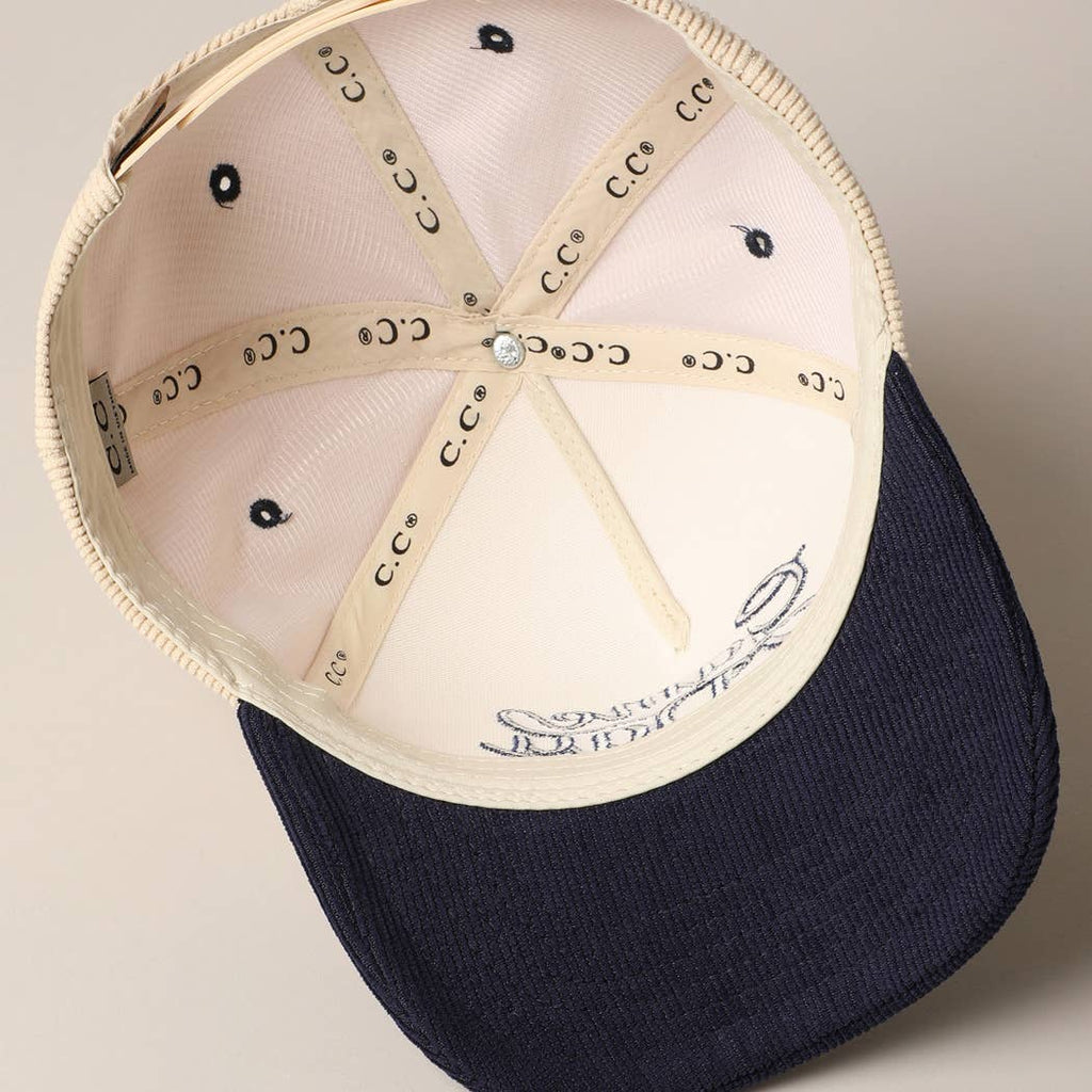 Corduroy trucker baseball cap with "Game Day" embroidered in navy on cream and navy fabric.
