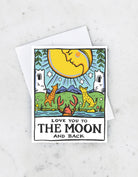A greeting card featuring a hand-painted illustration of the moon and stars with a quote 'Love you to the moon and back'. The card is blank inside and paired with a matching envelope.
