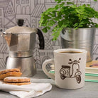 White ceramic mug with a black sketch of a vintage moped.