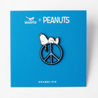 Snoopy enamel pin on a blue background labeled "Magpie + Peanuts," featuring a peace sign design.
