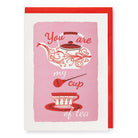 A greeting card featuring a steaming cup of tea.