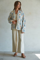 Quilted cotton jacket with desert-themed motifs and soft blue, cream, and terracotta tones