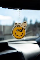 Peanuts® Snoopy Smiley Air Freshener with a vanilla scent, featuring Snoopy on a cheerful smiley face.