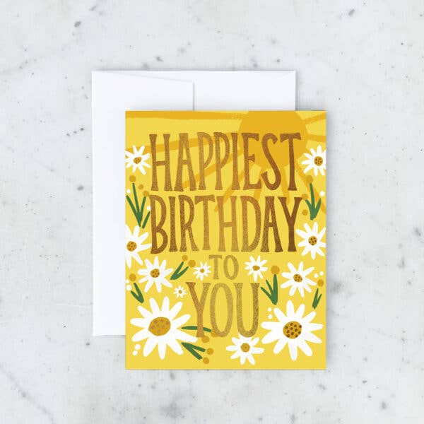 Birthday card with 'Happiest Birthday to You' text and daisy flowers on a yellow background