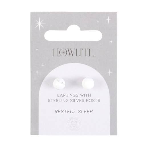Howlite crystal stud earrings on a matching backing card held by a hand with black nail polish.