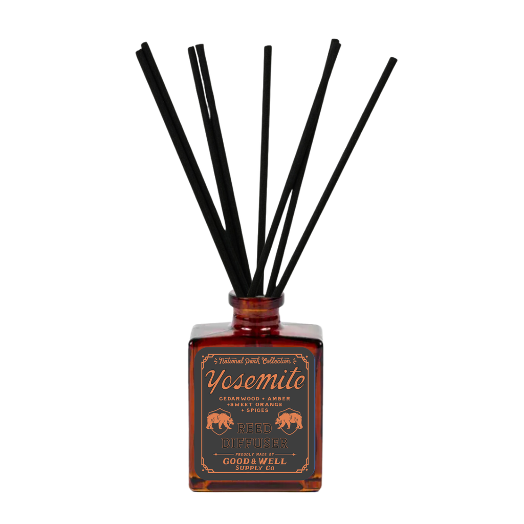 Yosemite reed diffuser with amber glass bottle and black reeds by Good & Well Supply Co., featuring cedarwood, amber, and orange.