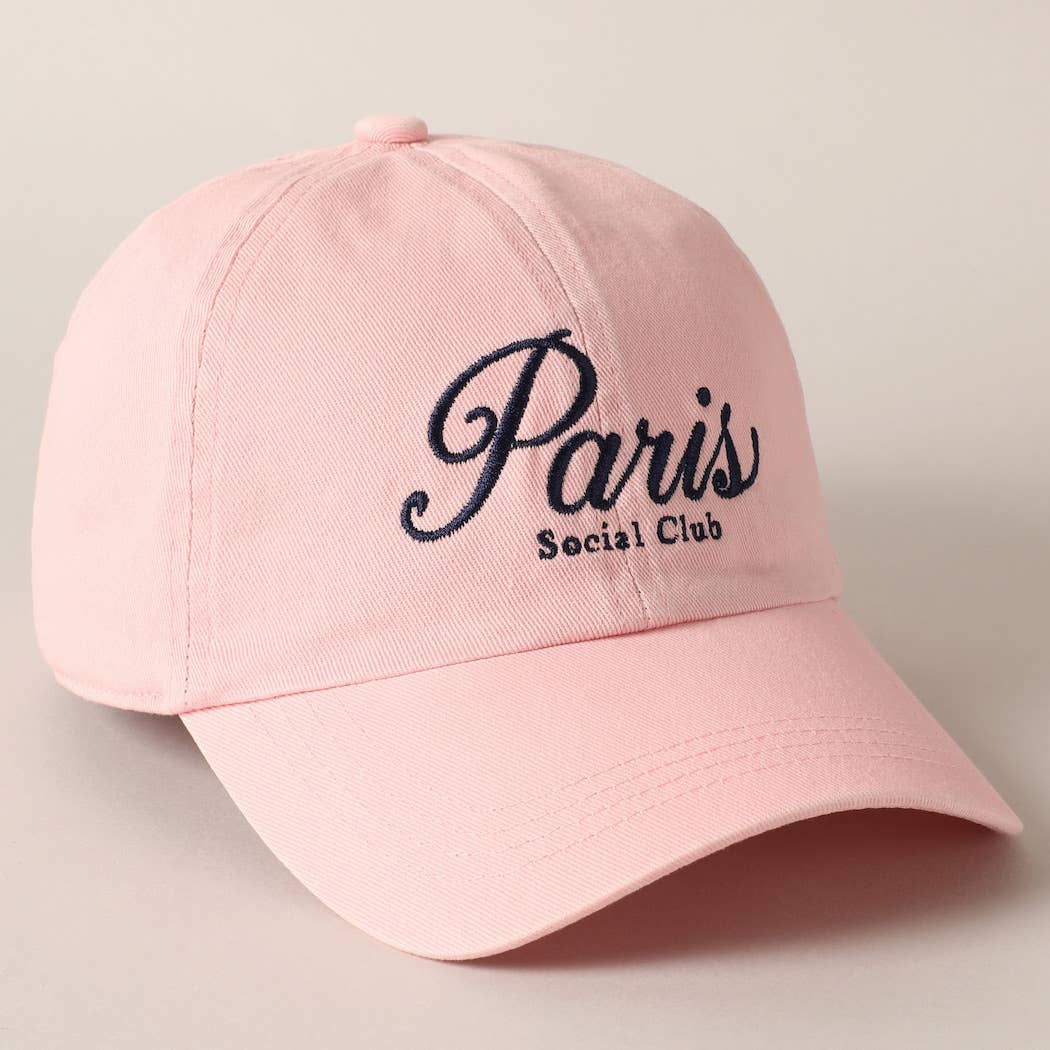 Pink cap with 'Paris Social Club' text on a light gray background