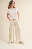 Wide-leg cotton-linen pants with smocked waistband and tassel drawstring