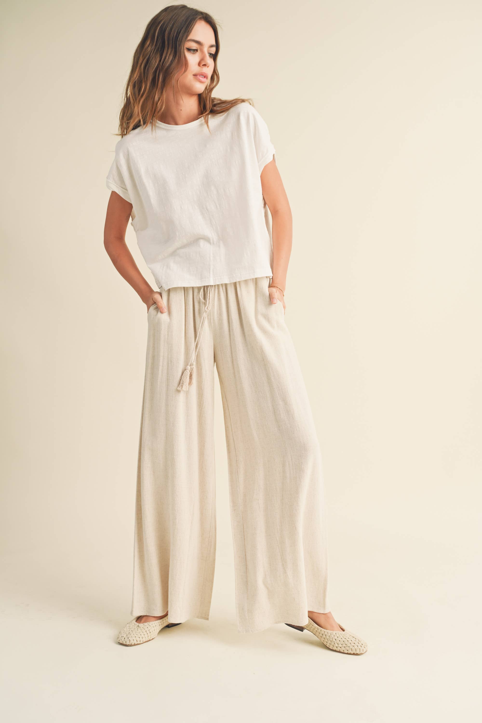 Wide-leg cotton-linen pants with smocked waistband and tassel drawstring