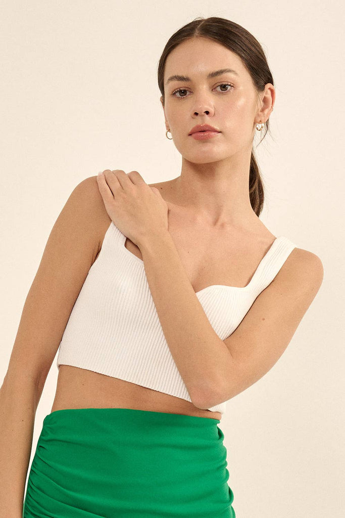 Woman wearing a white ribbed knit crop top with a sweetheart neckline and wide straps.