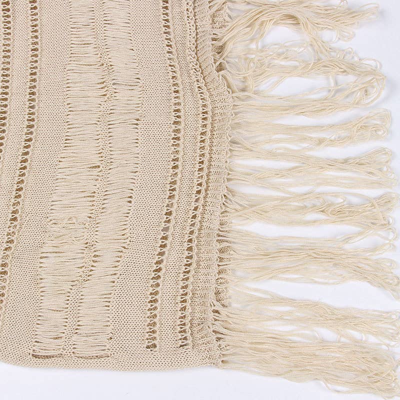 Woman wearing a Seaside Serenity Crochet Cover-Up Dress with a crochet design, adjustable spaghetti straps, and a fringe hem.