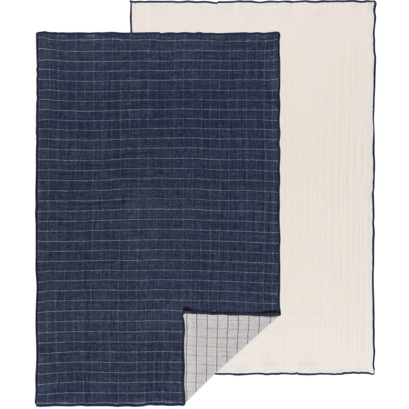 Two dishtowels, one with a midnight blue grid pattern on a light background and another with a solid light beige color, both laid out flat.