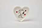Heart-shaped ceramic trinket dish with a black-and-white illustration of a smiling beagle, accented by red hearts, alongside a matching pink gift box.