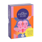 Your Cosmic Year astrology deck in bold orange, pink, and purple packaging with illustrated mirrored faces and celestial elements.