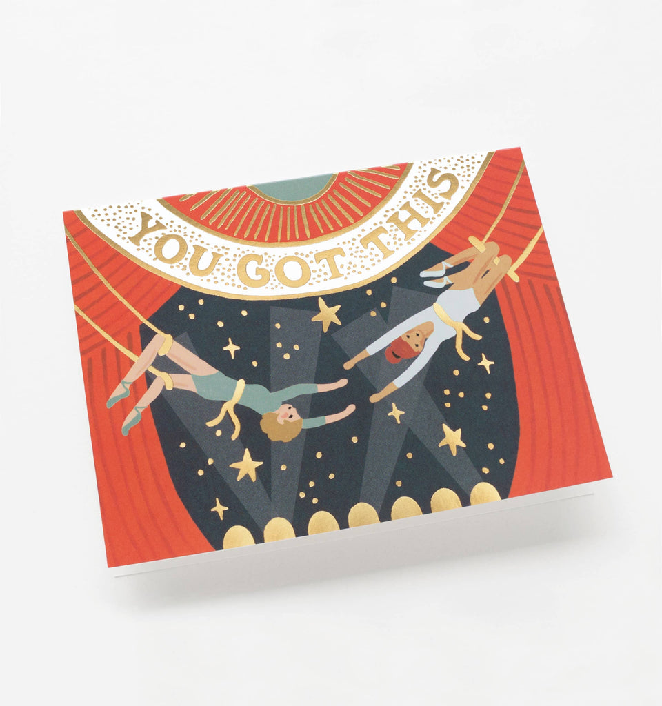 "You Got This" greeting card with a circus trapeze theme, gold foil lettering, and a matching gold envelope.