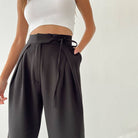 Woman wearing Urban Elegance Palazzo Pants in black color with a white crop top.