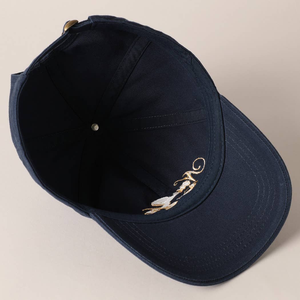 Beige and navy New York Social Club embroidered baseball caps with curved brims.