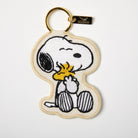 Embroidered keychain featuring a cute embrace, designed with high-quality stitching and a gold-toned keyring for a stylish touch.