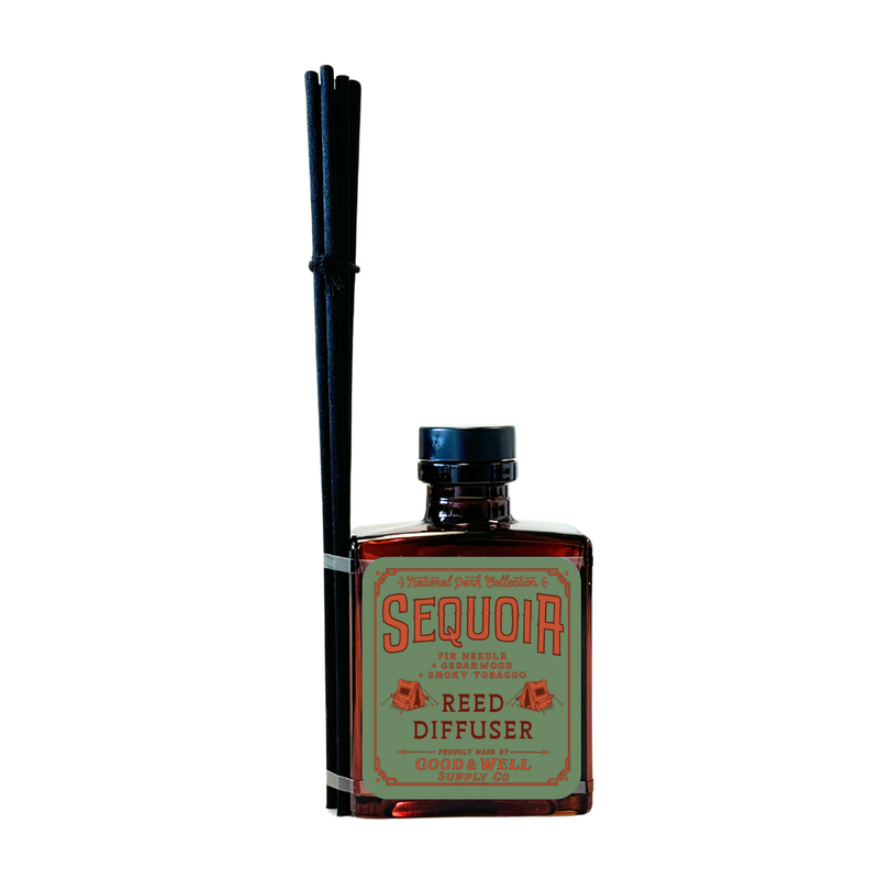 Hawai‘i Volcanoes reed diffuser with amber bottle and black reeds by Good & Well Supply Co., featuring wild fig, ginger, and citrus.