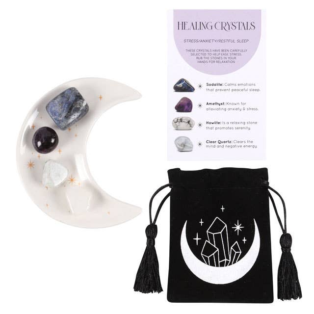 Stress Healing Crystal Set with Sodalite, Amethyst, Howlite, and Clear Quartz tumblestones on a crescent moon trinket dish, alongside a matching information card and printed drawstring pouch.