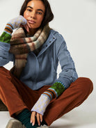 Woman wearing a Sahara Sky Hooded Jacket with a zip-up front, textured waffle knit, and button detailing in blue and brown tones.