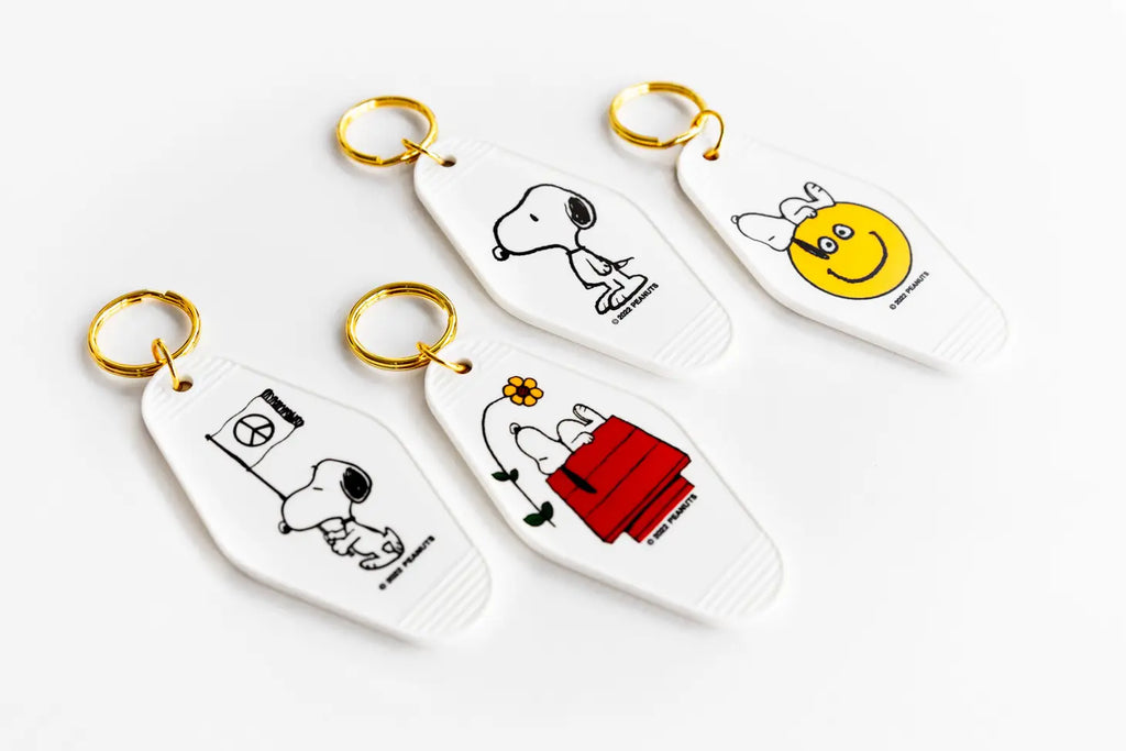 Peanuts Snoopy Smiley Key Tag - Snoopy with a big smile, a durable and charming key accessory spreading joy.