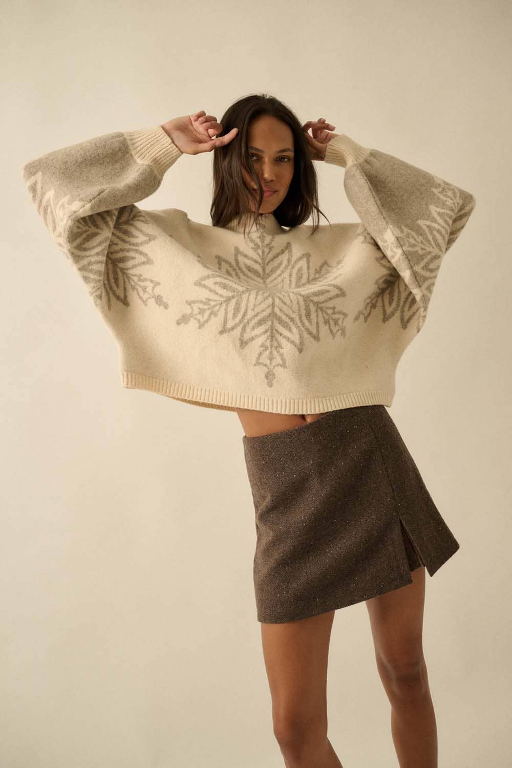 Oversized cream sweater with grey snowflake design.