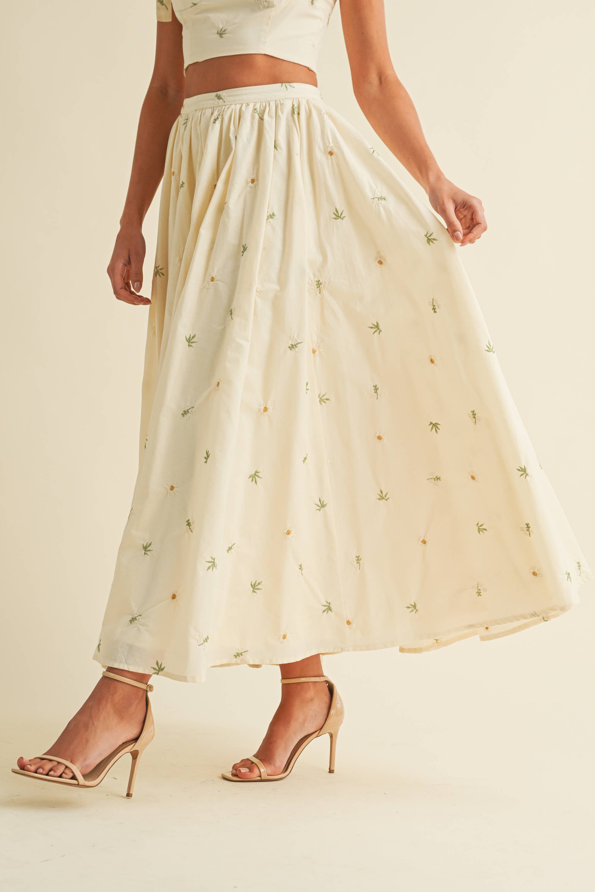 Light cream two-piece set with small floral embroidery, featuring bow-tie strap top and flowy maxi skirt