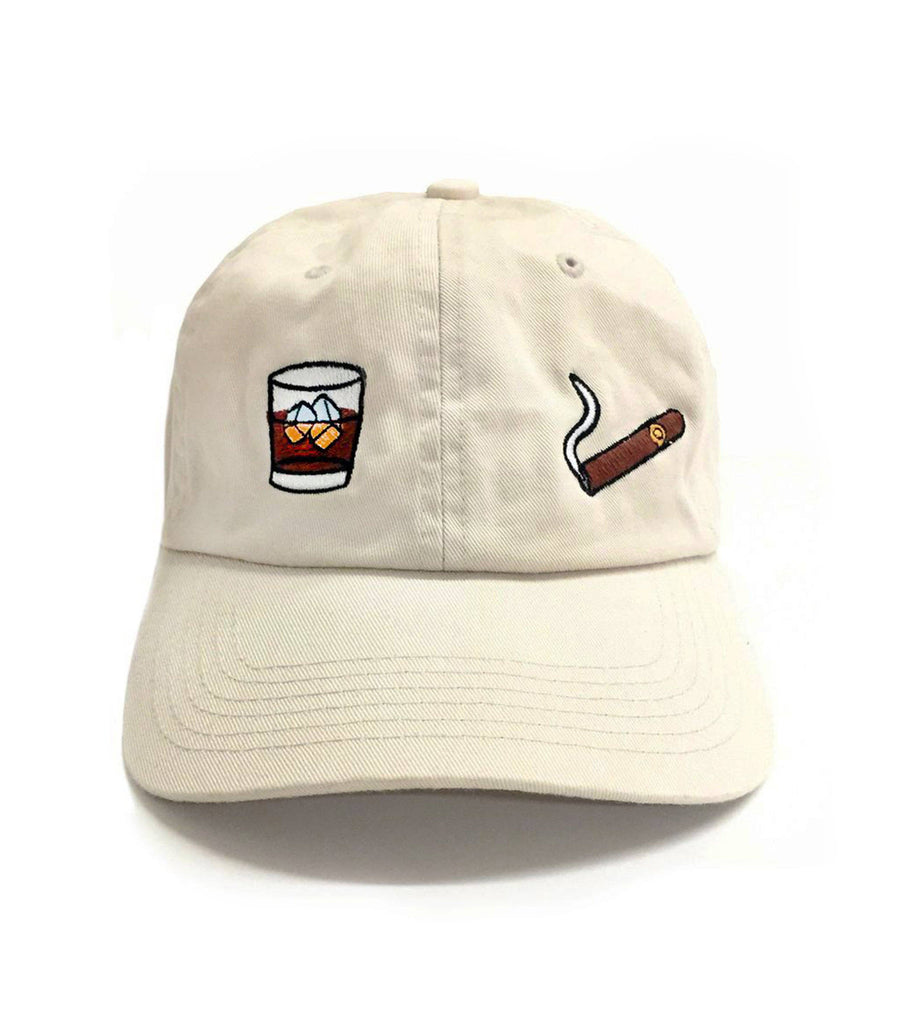 Beige baseball cap with embroidered whiskey glass and cigar design on the front.