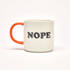 Ceramic mug with the bold text "NOPE" on a white background and a bright orange handle.