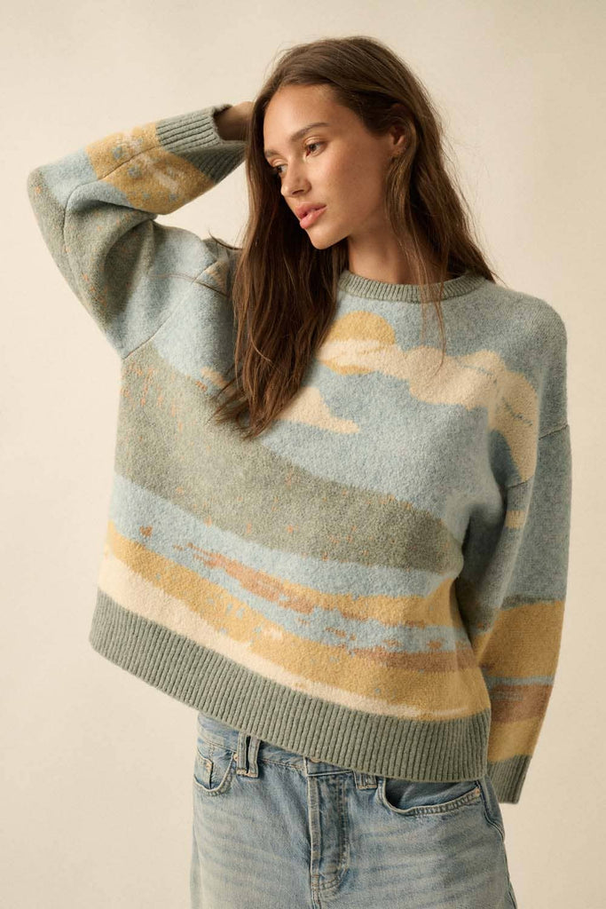 Woman wearing a sweater with cloud pattern against a beige background