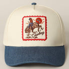 Cap with embroidered design of a cowboy on a horse, red border, and blue and white color scheme.
