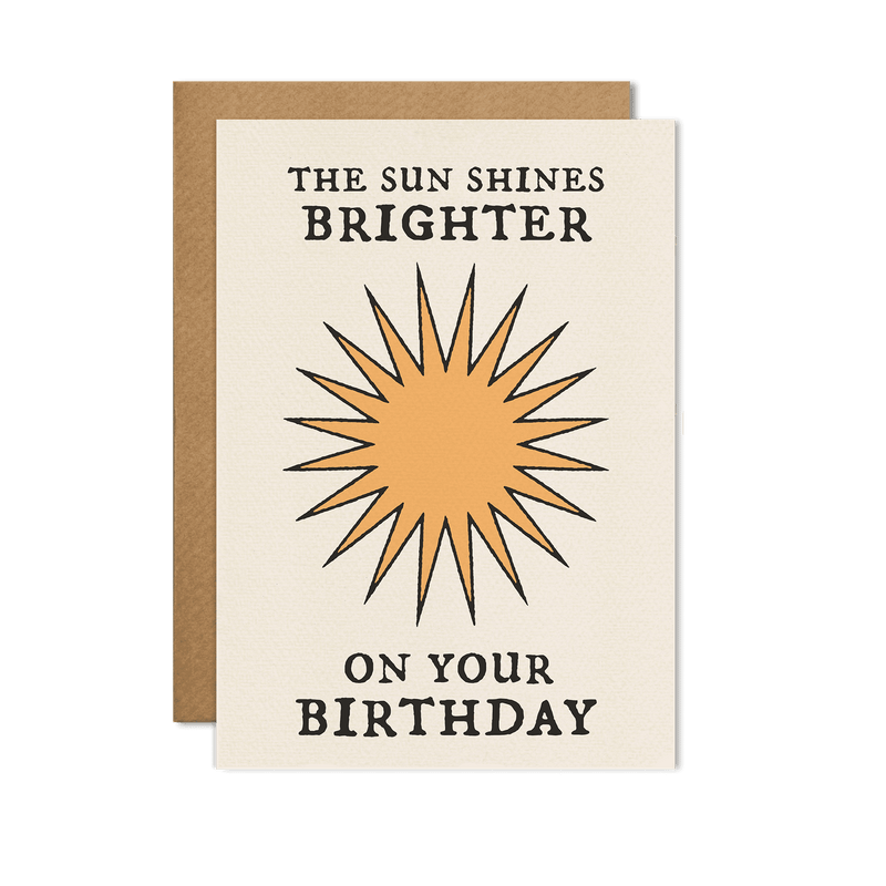 Minimalist birthday card with a sunburst design and bold typography that reads "The Sun Shines Brighter on Your Birthday."