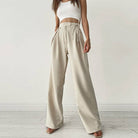 Woman wearing Urban Elegance Palazzo Pants in cream color with a white crop top.