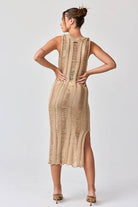 Woman wearing a sleeveless ladder knit midi dress.