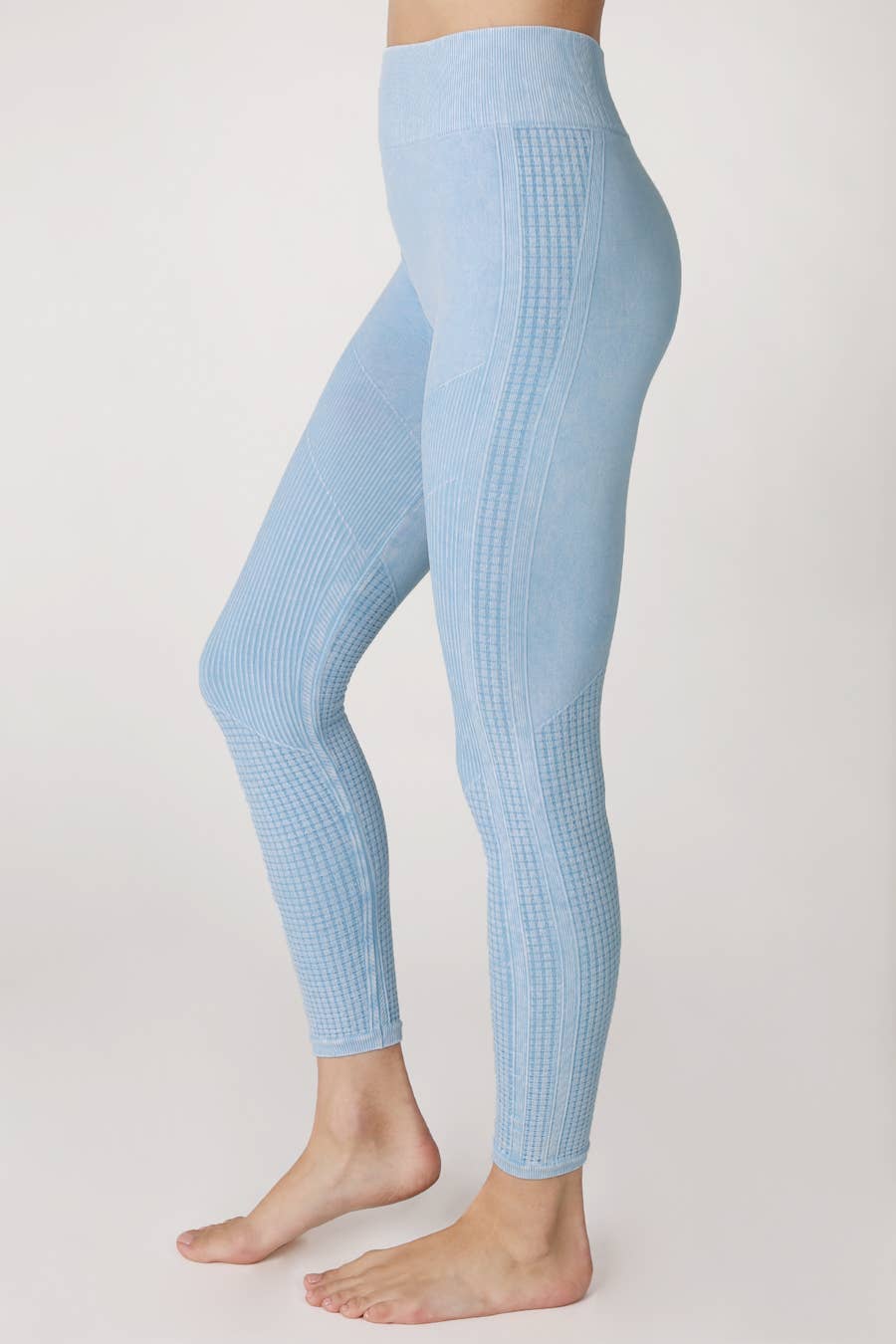 Woman wearing Harmony High-Waist Ribbed Leggings in light blue, featuring a high-rise fit and ribbed texture, perfect for workouts or casual wear.