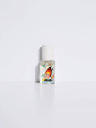 Maison Matine Lost in Translation perfume bottle with bold illustrated design, placed on vibrant yellow textured surface.