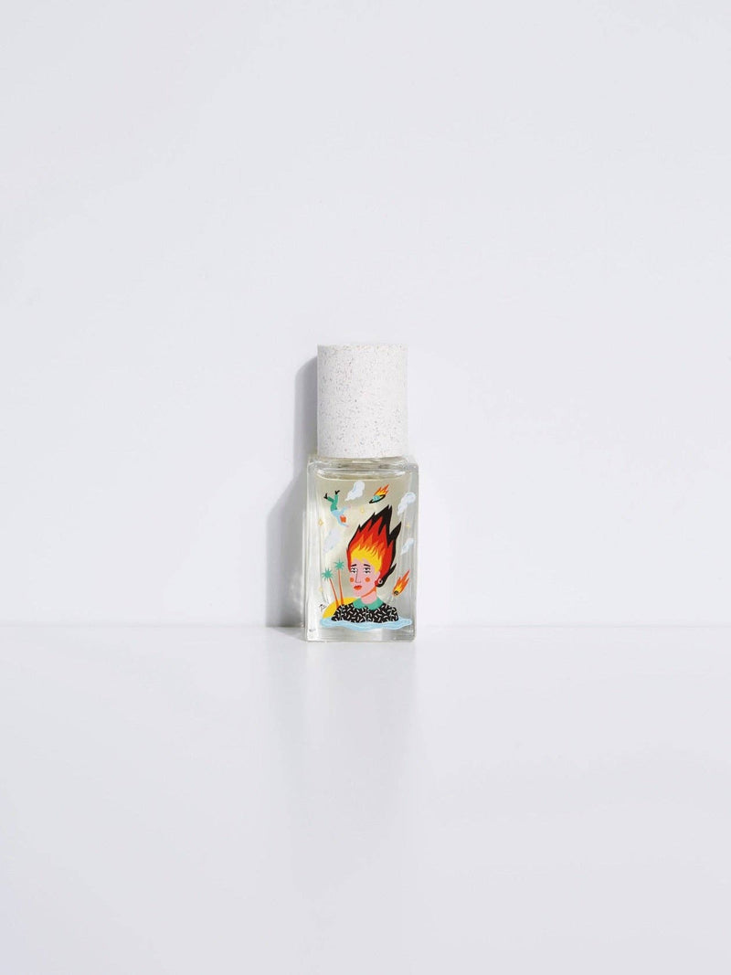 Maison Matine Lost in Translation perfume bottle with bold illustrated design, placed on vibrant yellow textured surface.
