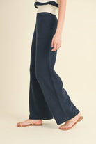 Model wearing navy blue knit wide-leg pants with a relaxed fit and soft texture.