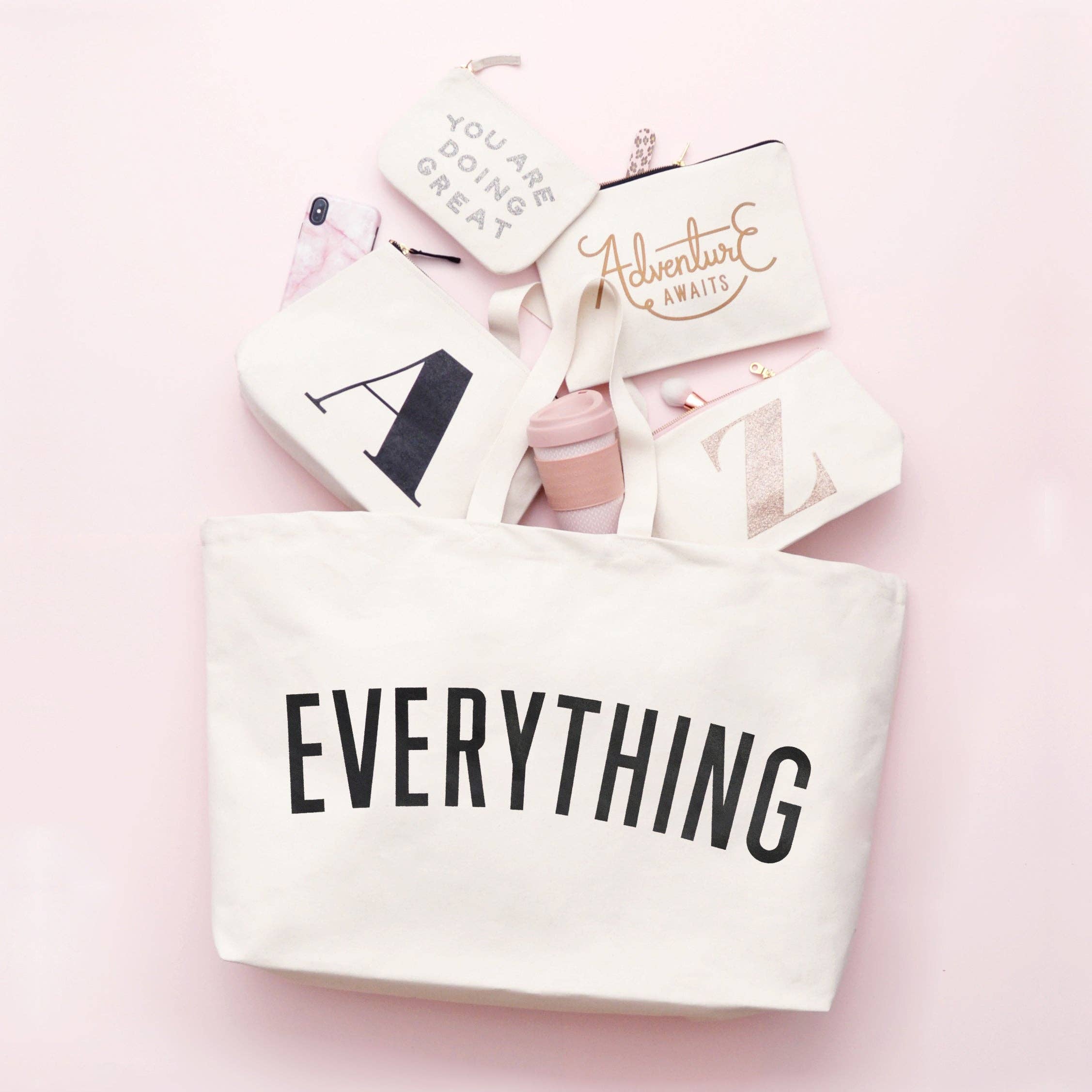 Coral tote bag with “Sunshine Appreciation Society” in white lettering, carried by a woman in a rust-colored embroidered dress