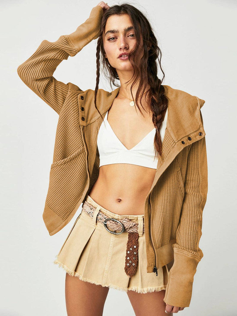 Woman wearing a Sahara Sky Hooded Jacket with a zip-up front, textured waffle knit, and button detailing in blue and brown tones.