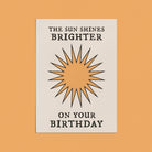 Minimalist birthday card with a sunburst design and bold typography that reads "The Sun Shines Brighter on Your Birthday."